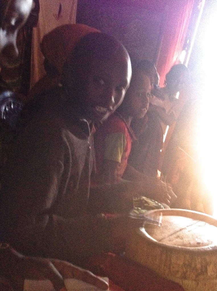 Eleven-year-old Abraham playing the make-shift drum