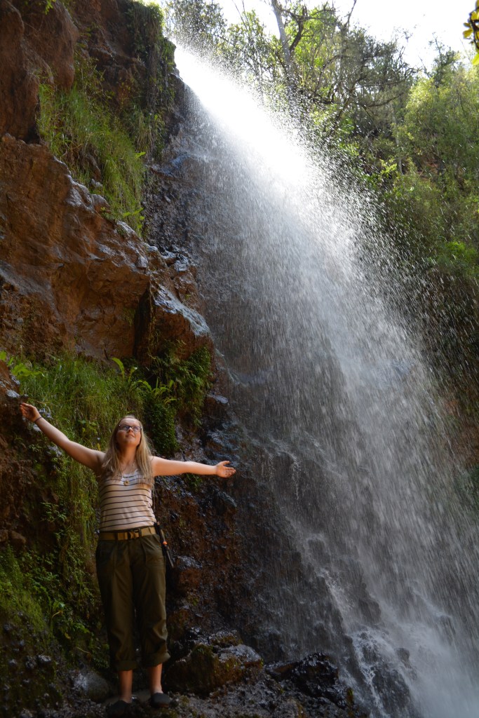 Enjoying the spray of the beautiful waterfall