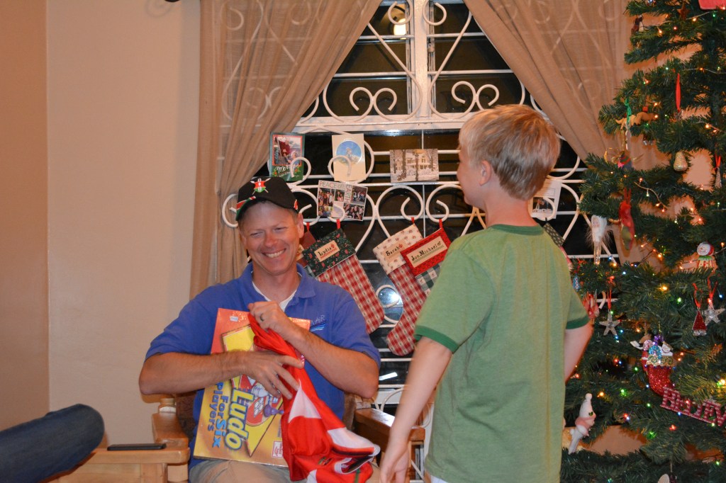On January 6th, we celebrate Epiphany by giving gifts to each other as the Wise Men brought gifts to Jesus.  Here Abraham is giving Dan his gifts of a Kenyan hat, football jersey, and a new game for the family to play.  We ended the night eating our "Treasure Chest" cake, representing the treasures the Wise Men brought to Jesus.